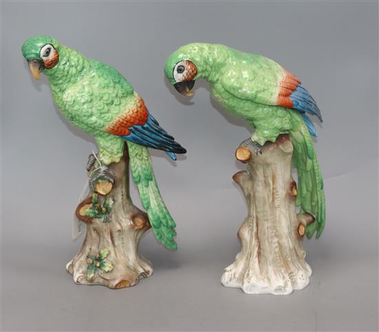A pair of Continental porcelain models of parrots, with a gold painted anchor to the base, height 34cm